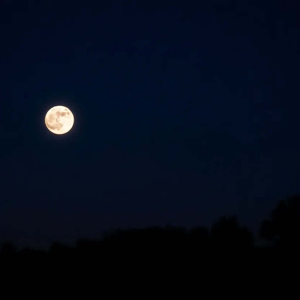 Full Corn Moon and Saturn glowing in the night sky over Indianapolis.