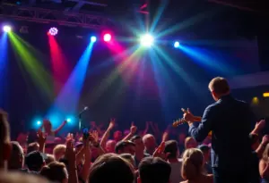 Concert audience enjoying a performance of a bluegrass artist on stage.