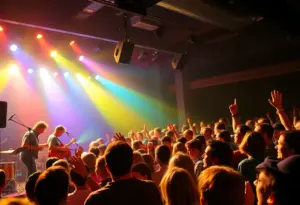 Concert audience enjoying Zach Pietrini's live performance with colorful stage lights.